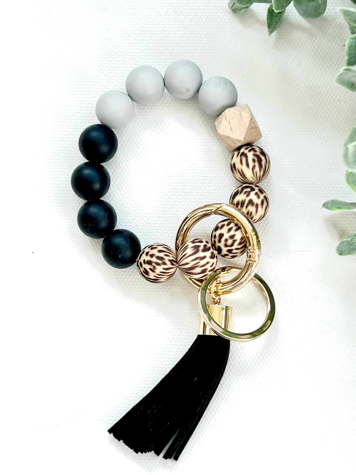 Silicone & wood beads with a leather tassel.