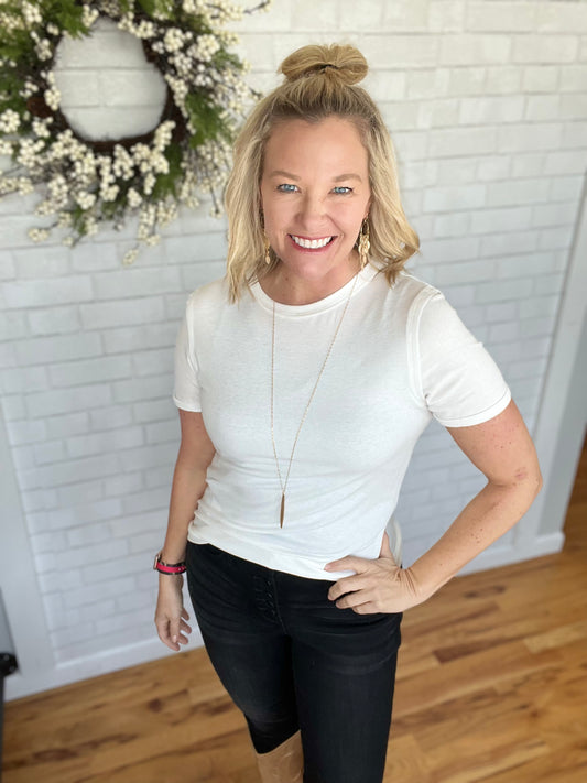 This tee has some great detailing: raw edging around collar and shoulder and a petite cuff at sleeve. Super soft to the touch.