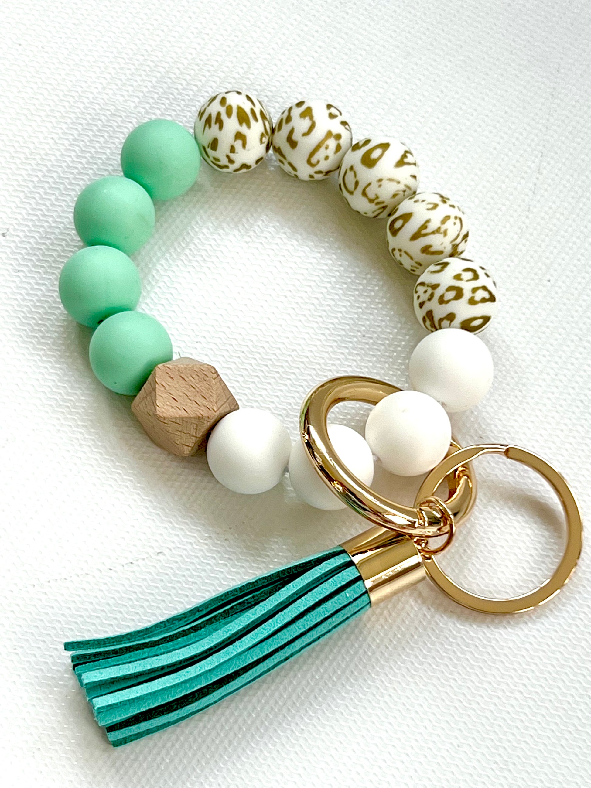 Silicone & wood beads with a leather tassel.